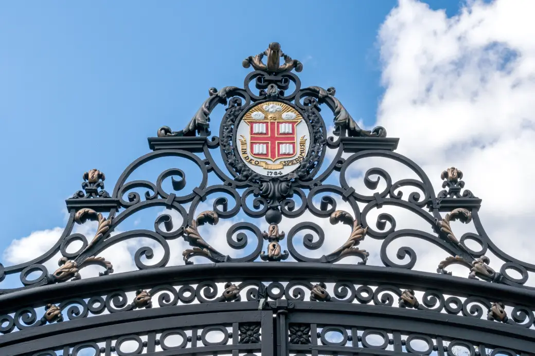 Iconic Brown University gate and crest, highlighted by Opus College Prep for college admissions insights
