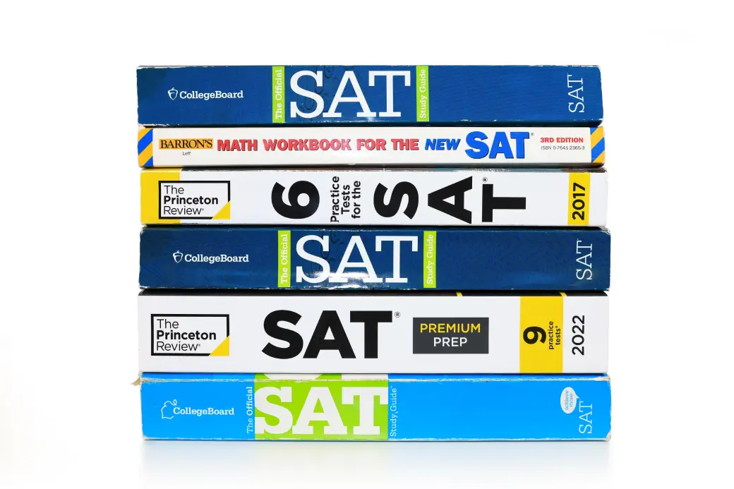 SAT prep books stack from CollegeBoard and others, used by Opus College Prep.